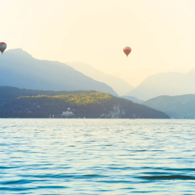 Colourful Hot air balloons flying over Annecy lake in the morning, France